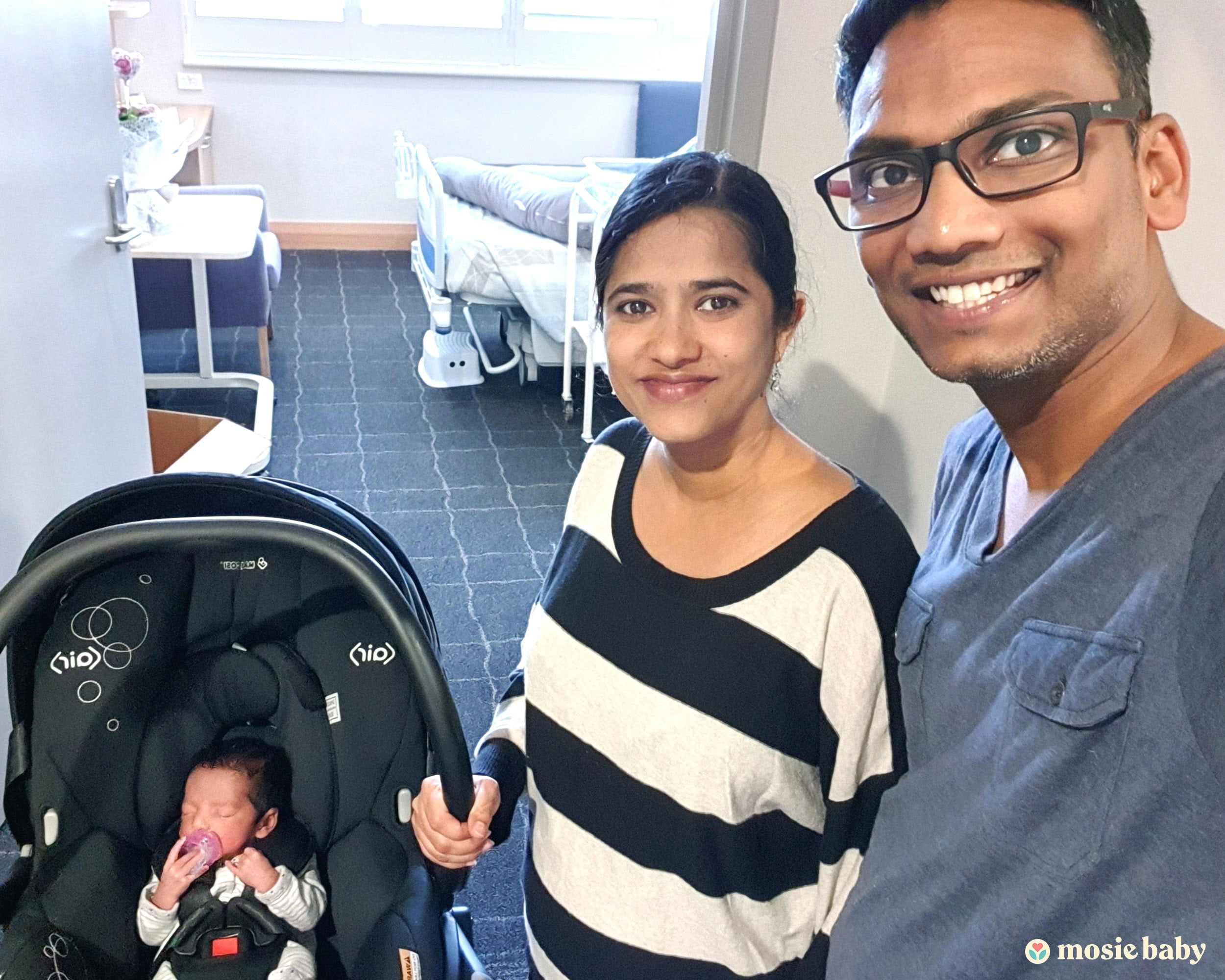 mom and dad with their newborn mosie baby