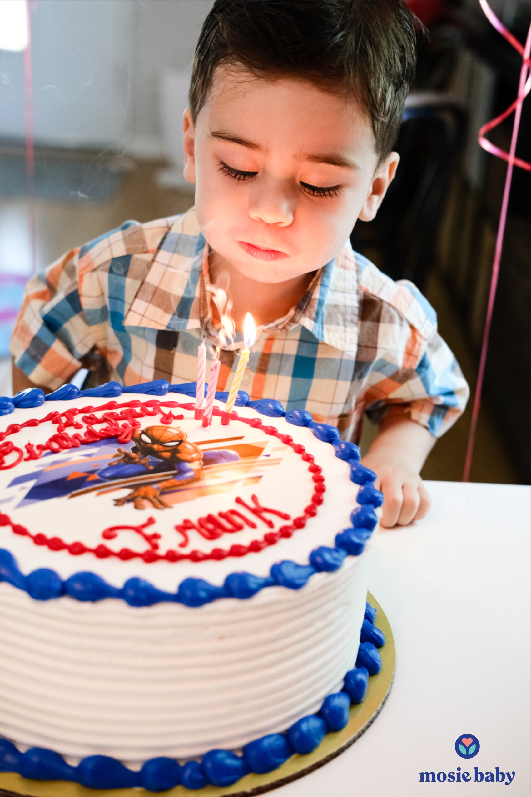 the first mosie baby blowing out birthday candles